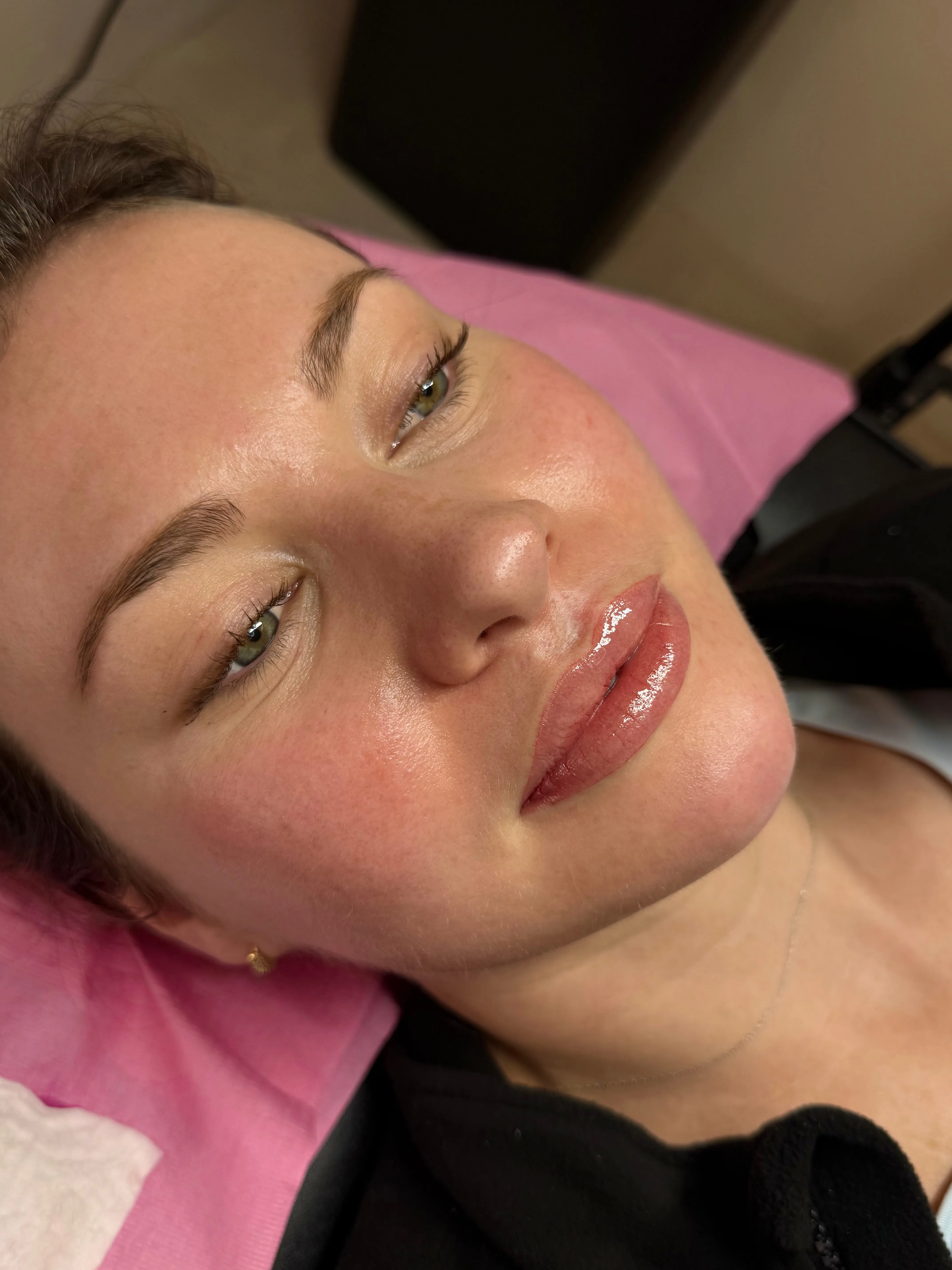 A client resting after her session, lips freshly done